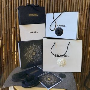 CHANEL bundle of boxes, cards and shopping bags